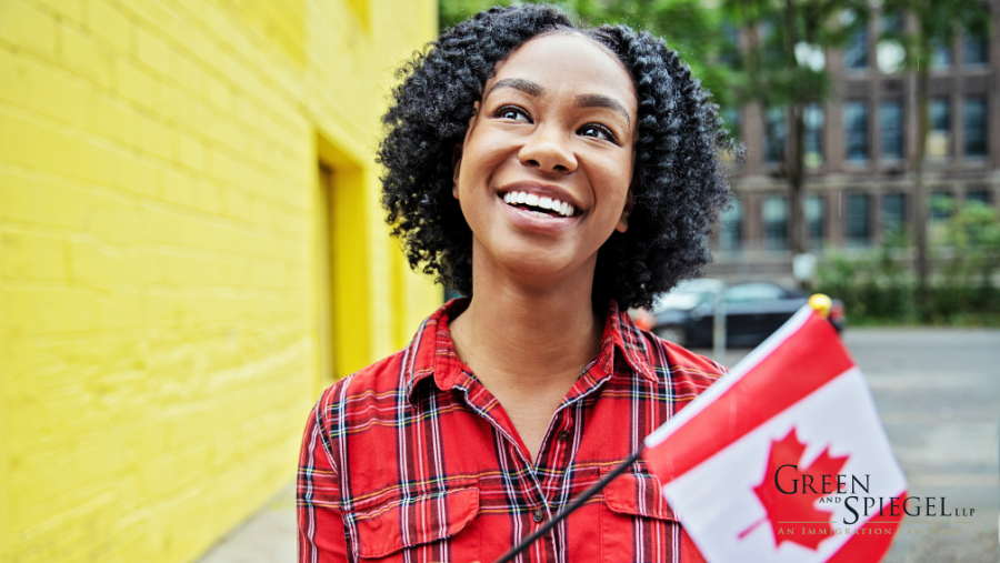 Woman smiling holding Canadian flag.