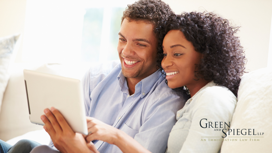 Couple smiling looking at tablet