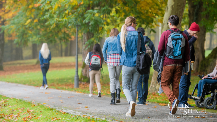 International students walking on university campus. International student fraud