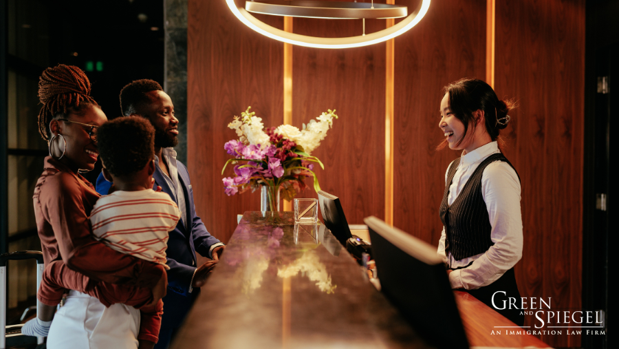 Family checking in at front desk of hotel - Hospitality Industry and Canadian Immigration